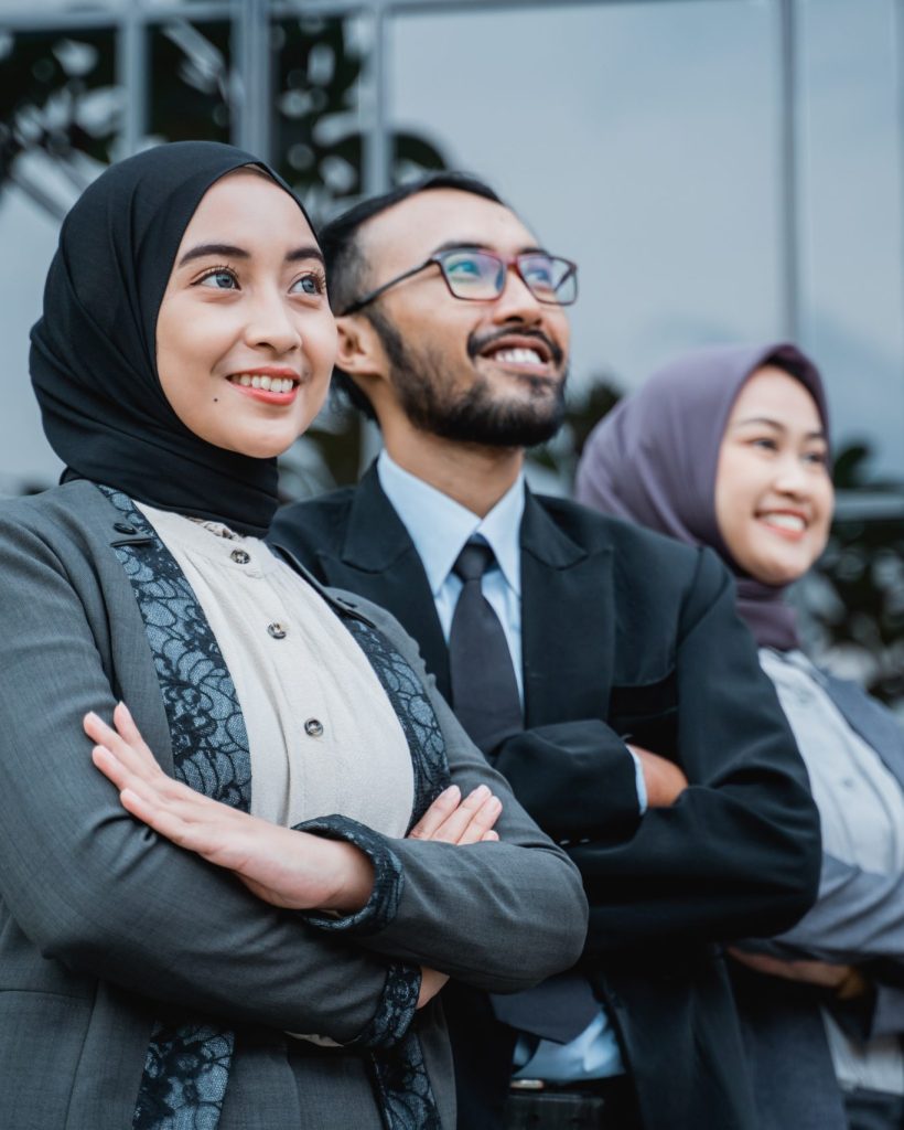 confident business muslim woman with partner standing and looking up as they are looking at their business vision